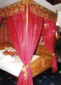 Lavishly decorated and romantic four poster bed at Longcombe in Devon