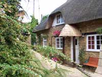 small thatched cottage in the country