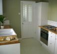 Kitchen with gas hob electric oven microwave and dishwasher 