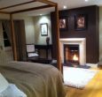 Snuggle up by the fire in our four poster bed