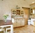 As you enter, the kitchen is to the left