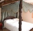 The king size hand carved four poster in Threshers Barn