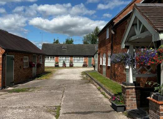 Granary Court yard with view of parking End Barn Laundry room and games room