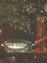 Norwich - Forum in glass with an illuminated Church to the right