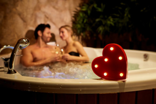 Couple relaxing in hot tub on holiday