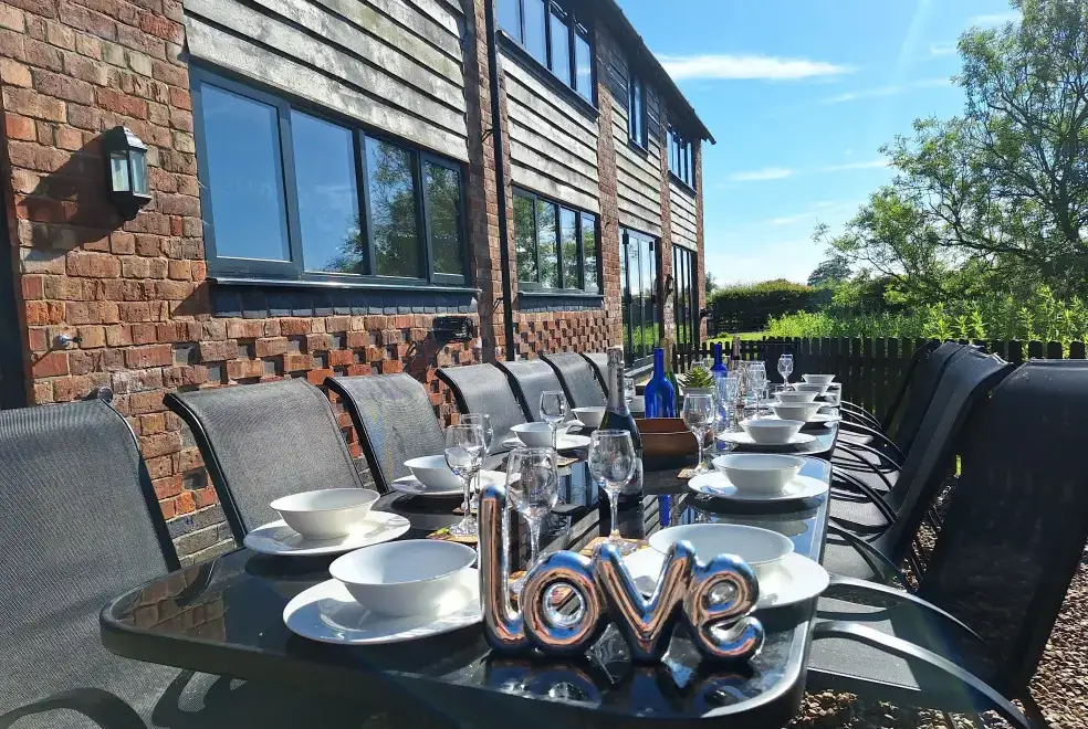 Patio area at Buttercups & Hayloft Sleeps & Dines 16 with Pool, Sports Court & Play Area