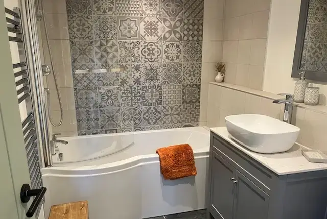 Bathroom with shower over bath at Lingcombe Barn in Dartmoor