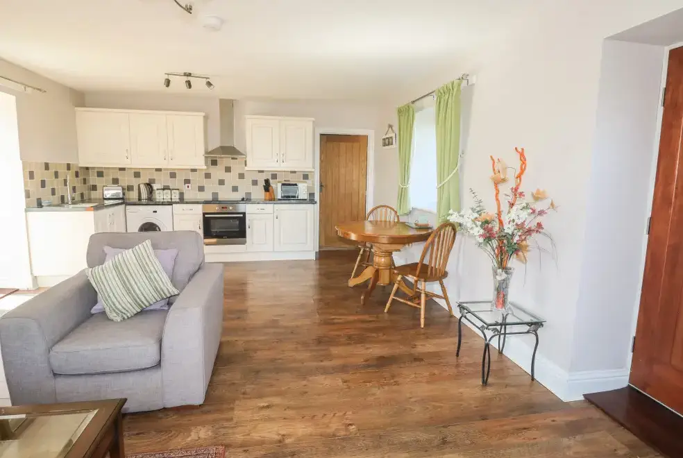 Open plan living area at Middle Barn Dogs-welcome Cottage, South West England