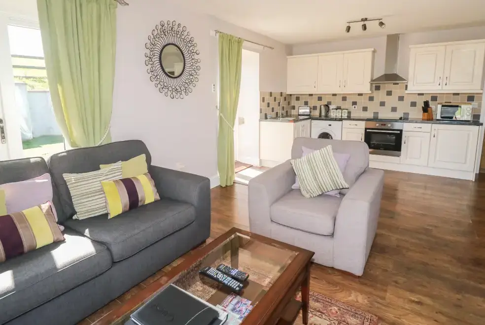 Open plan living area at Middle Barn Dogs-welcome Cottage, South West England