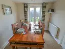 Dining room at Saddlers Cottage, Berllandeg Farm - thumbnail photo