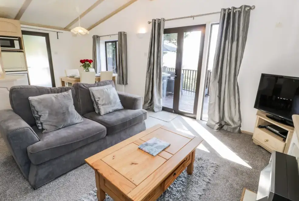 Open plan living area at Springtime Log Cabin