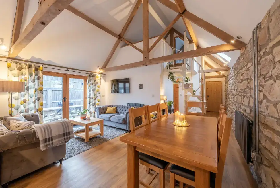 Open plan living area at The Barn with hot tub