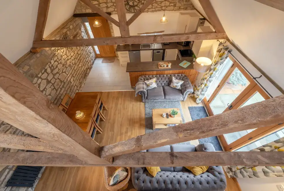 Open plan living area at The Barn with hot tub