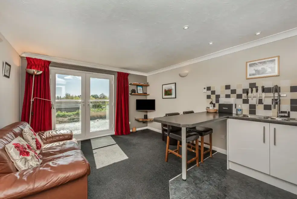 Open plan living area at The Boathouse Romantic Apartment