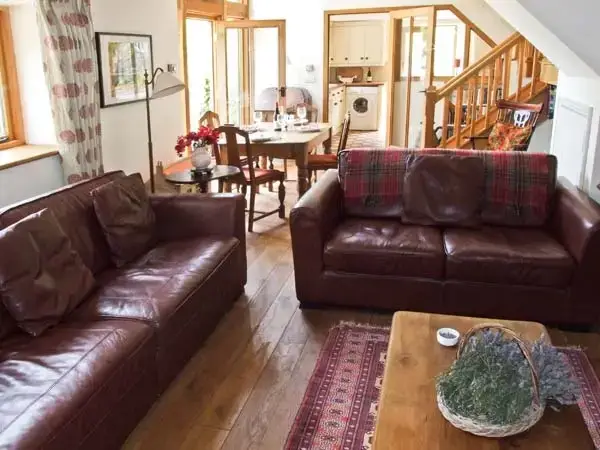 Open plan living area at The Lodge Farm Barn, Heart Of England