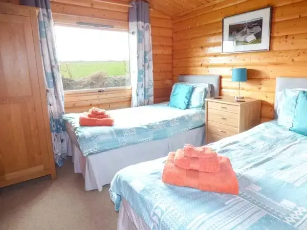 Bedroom at Ty Pren Pet-Friendly Log Cabin, South Wales 