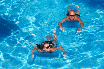 Couple Swimming at Holiday Cottage